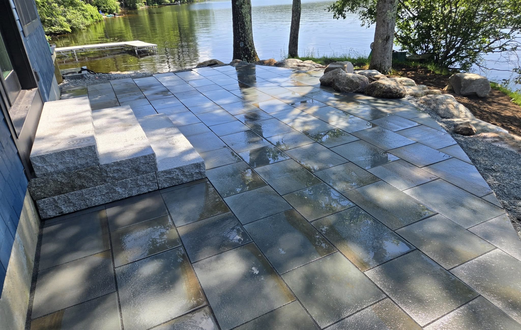 Completed stone patio and retaining wall hardscaping project