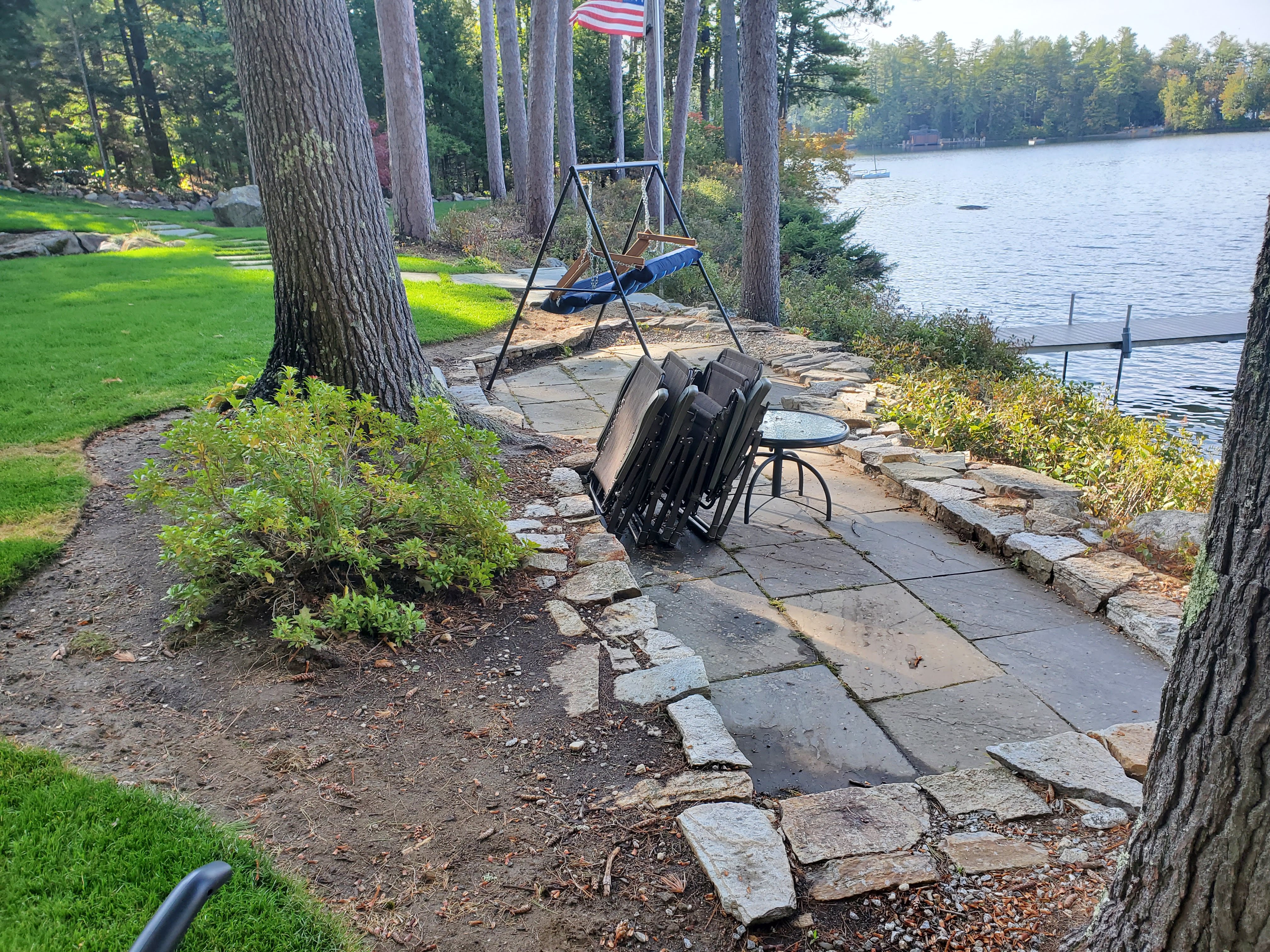 Older mismatched flagstone patio with folding chairs