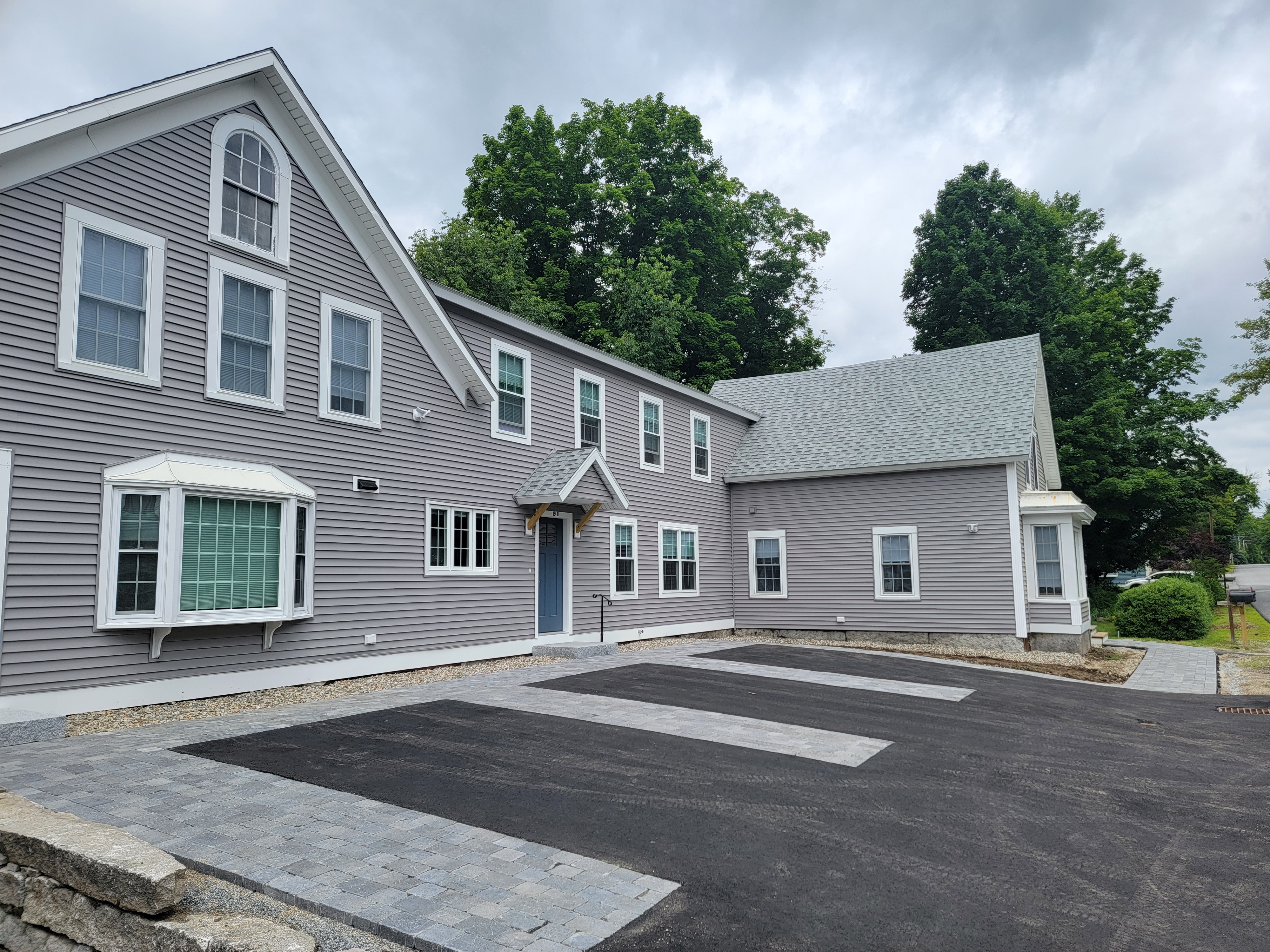 Same building with fresh asphalt drive and paver walkway