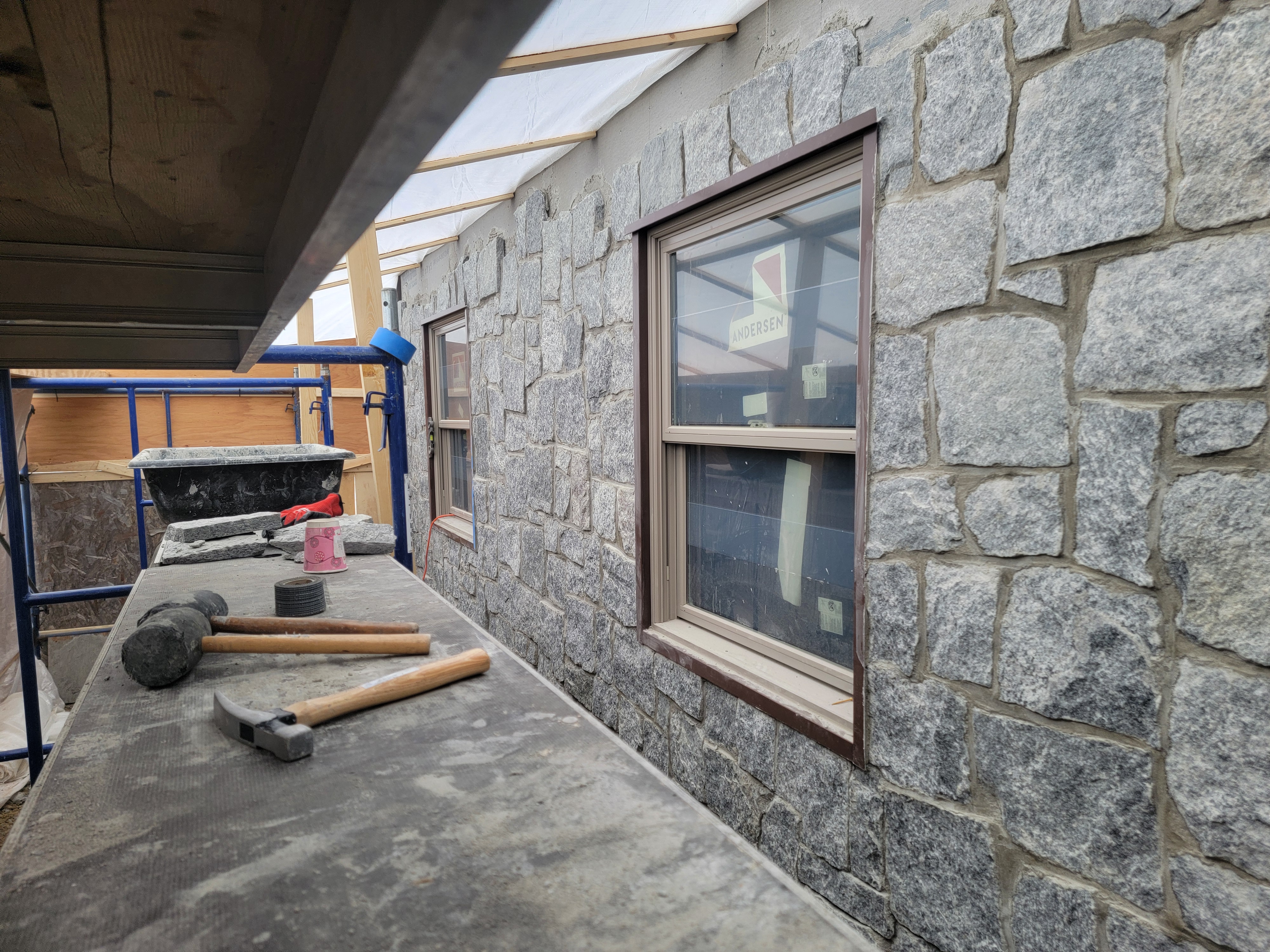 Finished stone veneer wall with wood-trimmed window